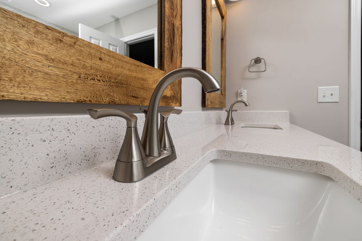Brushed nickel faucet on a white vanity, the kind of cold softened tap to flush and test the morning after an emptied softener's first regeneration