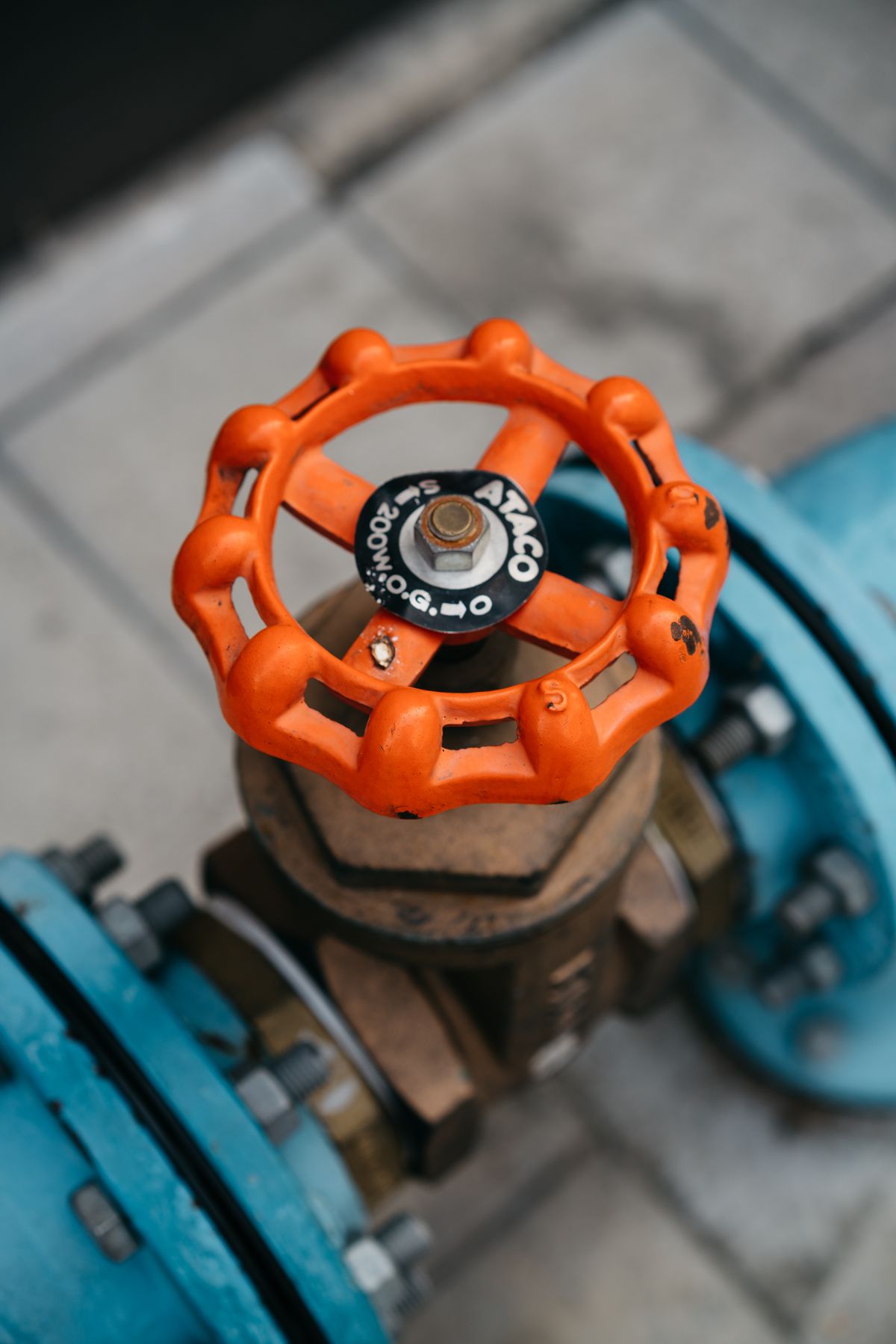 Close-up of a valve fitted to a pipe, the kind of threaded, sealed joint that begins to weep when a water softener control head seal or O-ring fails