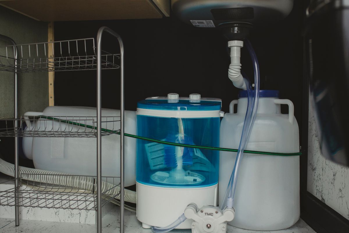Compact washing machine with supply tubing in a utility space, one of several appliances whose inlet screen traps escaped resin beads