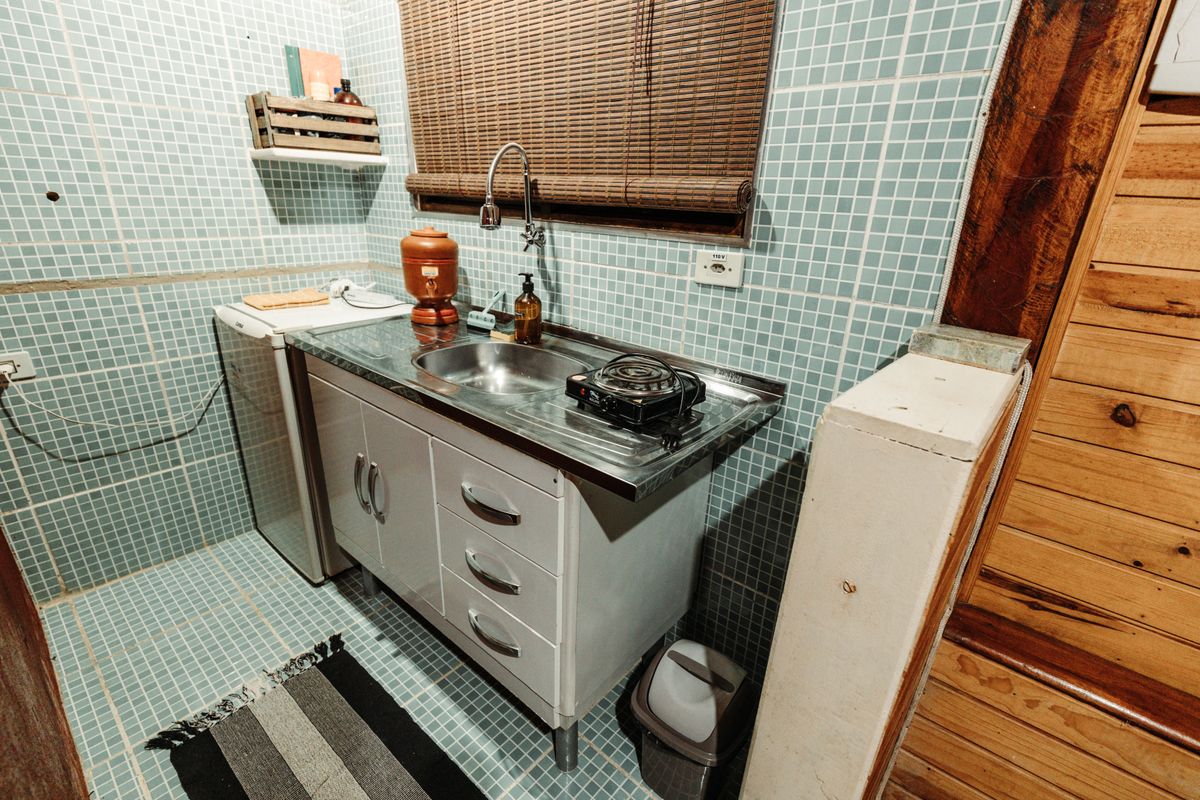Small apartment kitchen with a metal sink and minimal cabinets, the kind of tight space a compact water softener for an apartment has to fit around