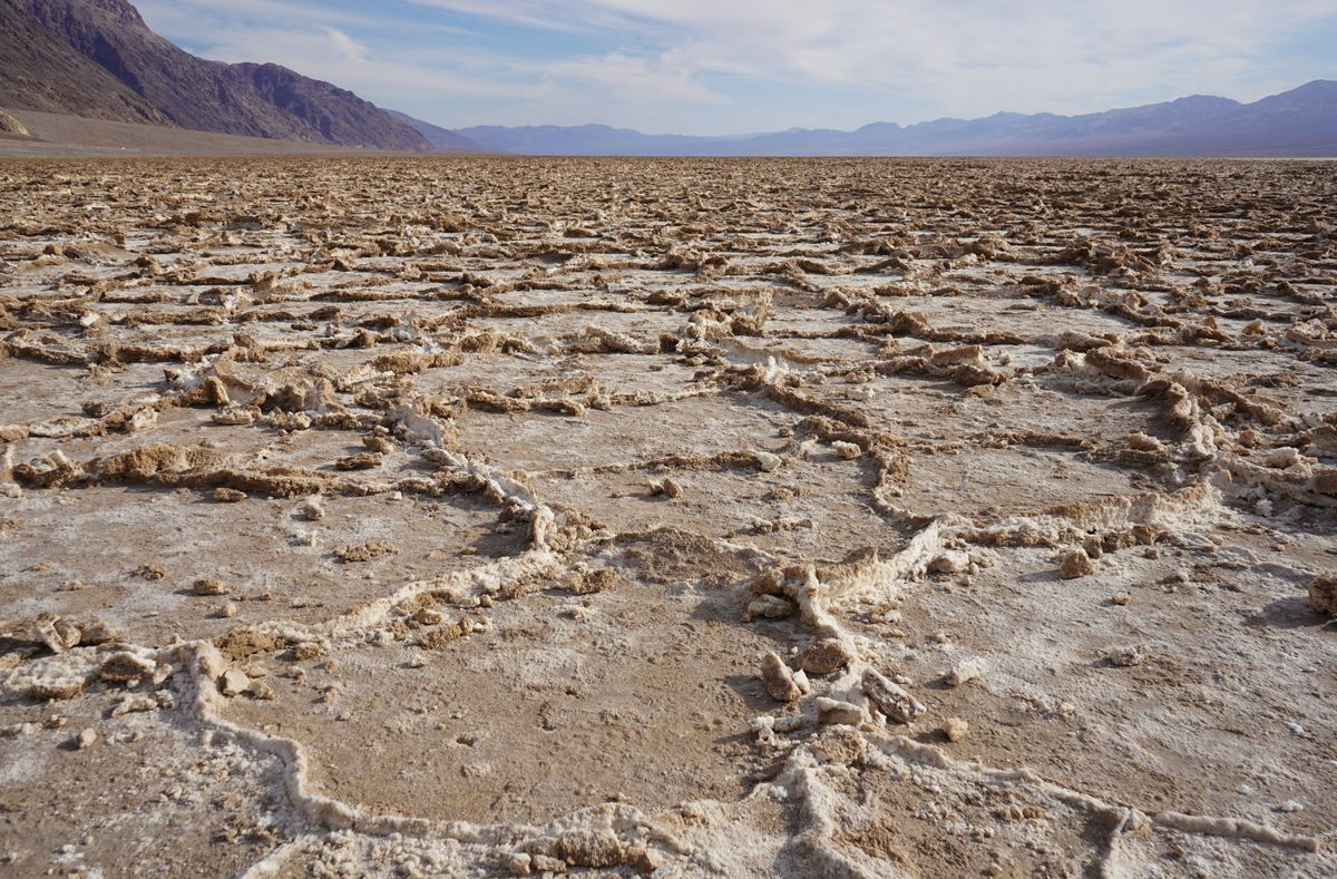 White salt crust on cracked ground at Badwater Basin, the residue left when salty water evaporates from soil
