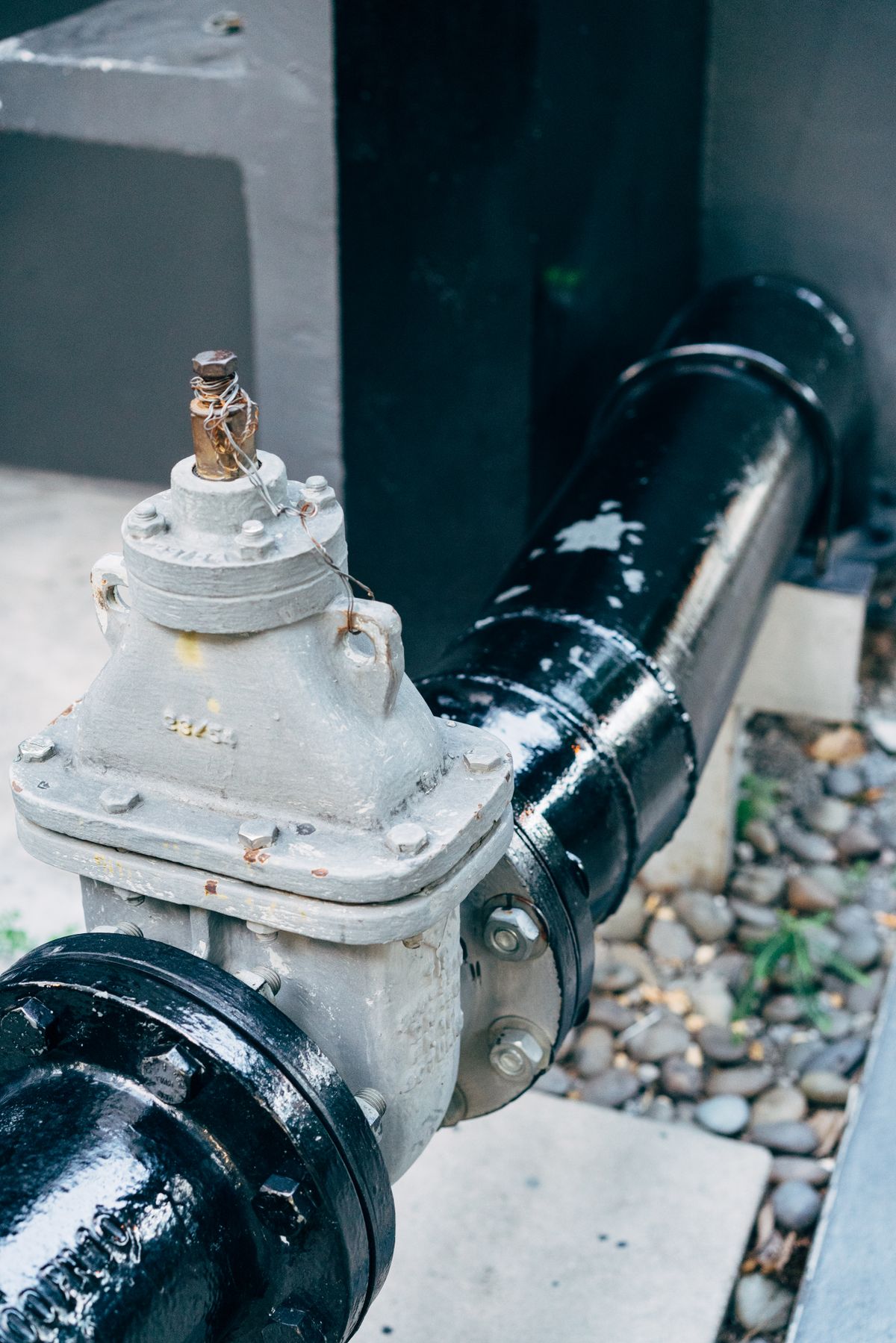 Plumbing valve on a black pipeline, the kind of restriction that prevents a softener from flushing brine to the drain during regeneration