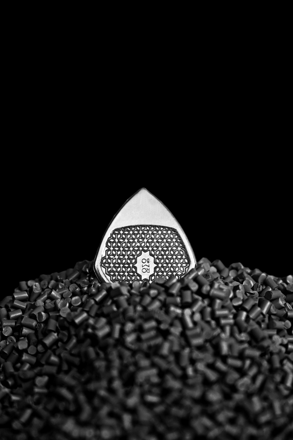 Close-up of black rubber granules, the material that sheds from hardened O-rings and seals inside an ageing softener valve