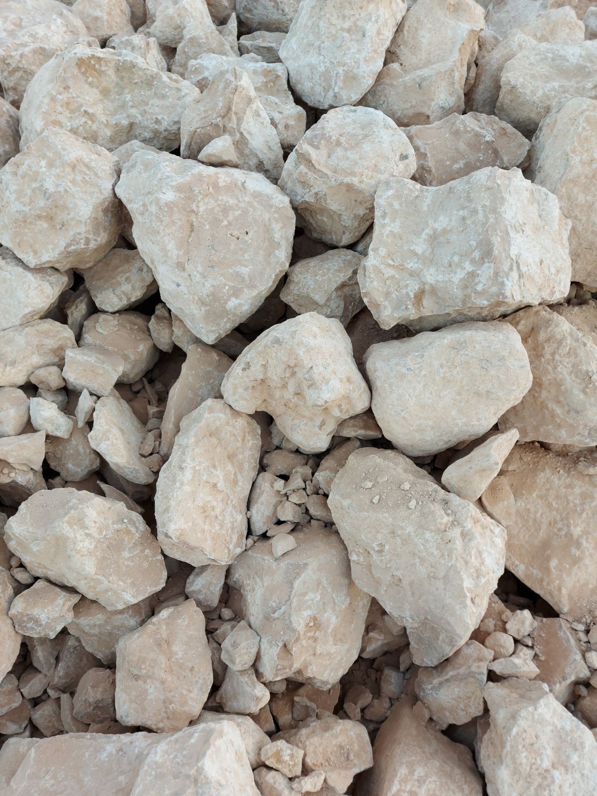 Pile of pale limestone rocks, the calcium carbonate that water hardness readings in ppm and grains per gallon are expressed against