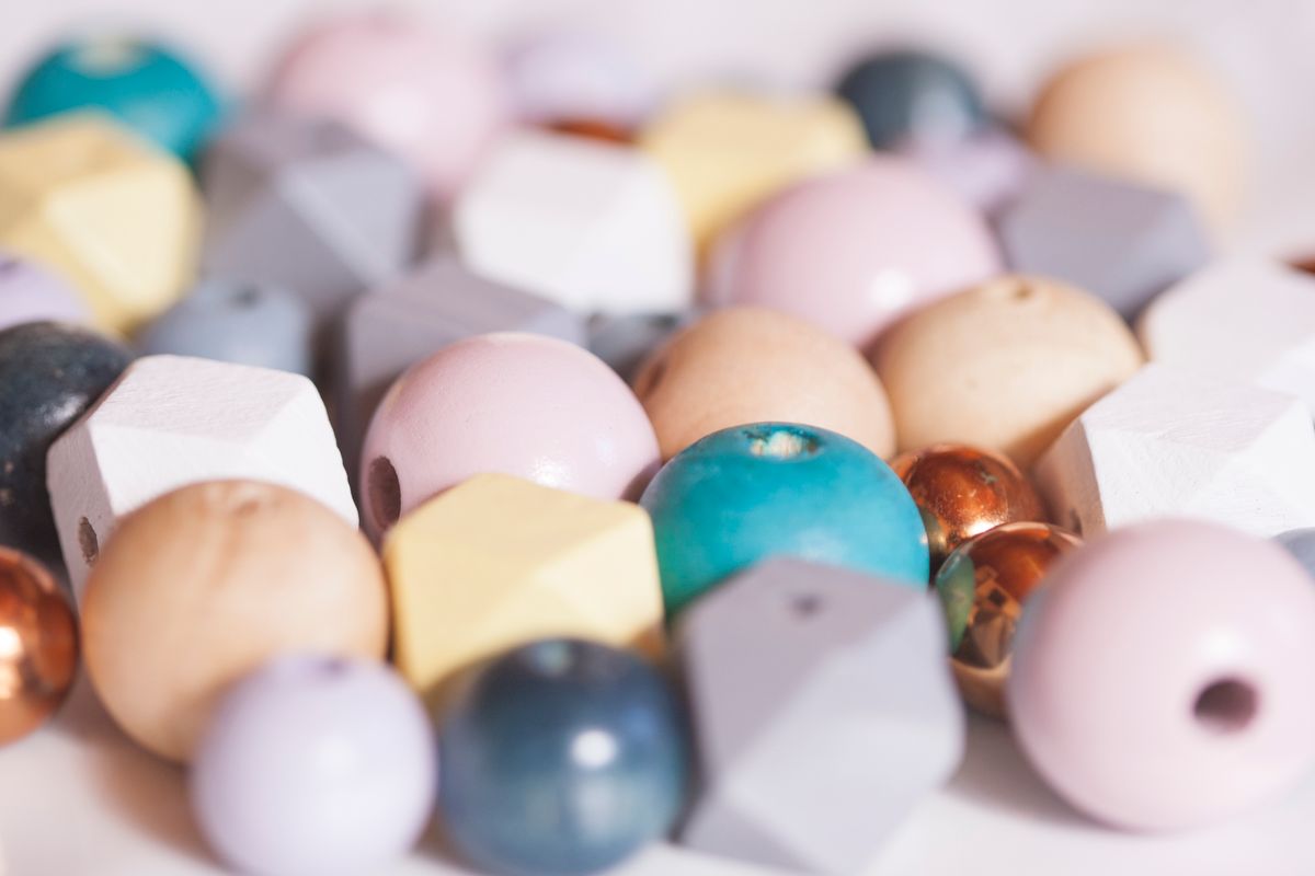 Assorted translucent beads in pastel colours photographed close up, showing the size and uniformity a healthy resin sample should display