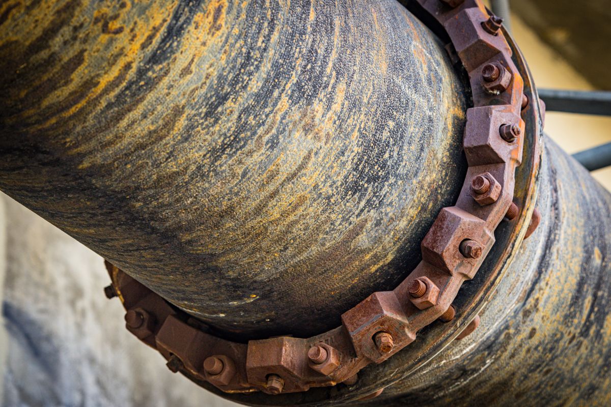 Interior of a large steel pipe, the kind of surface that accumulates decades of scale before softened water begins to undermine it