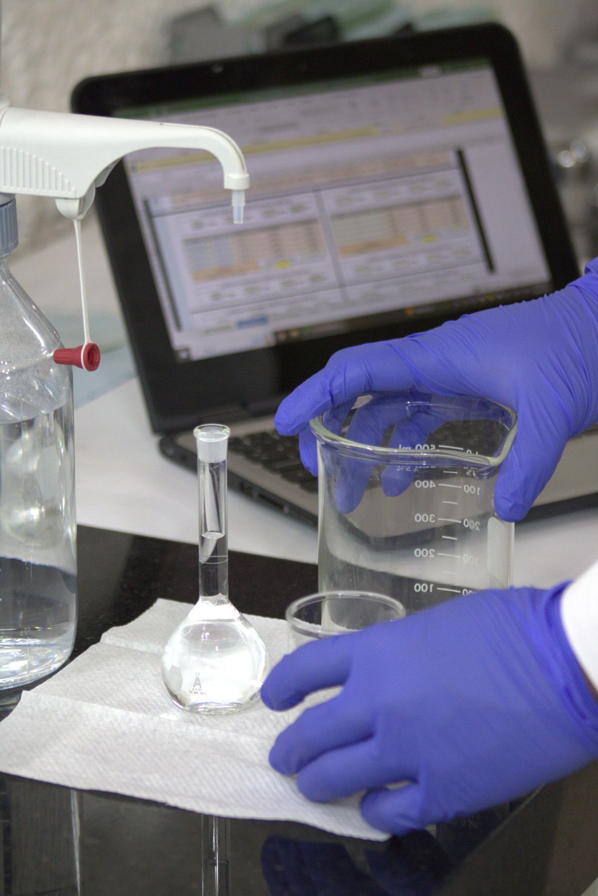 Laboratory technician transferring a water sample for iron analysis