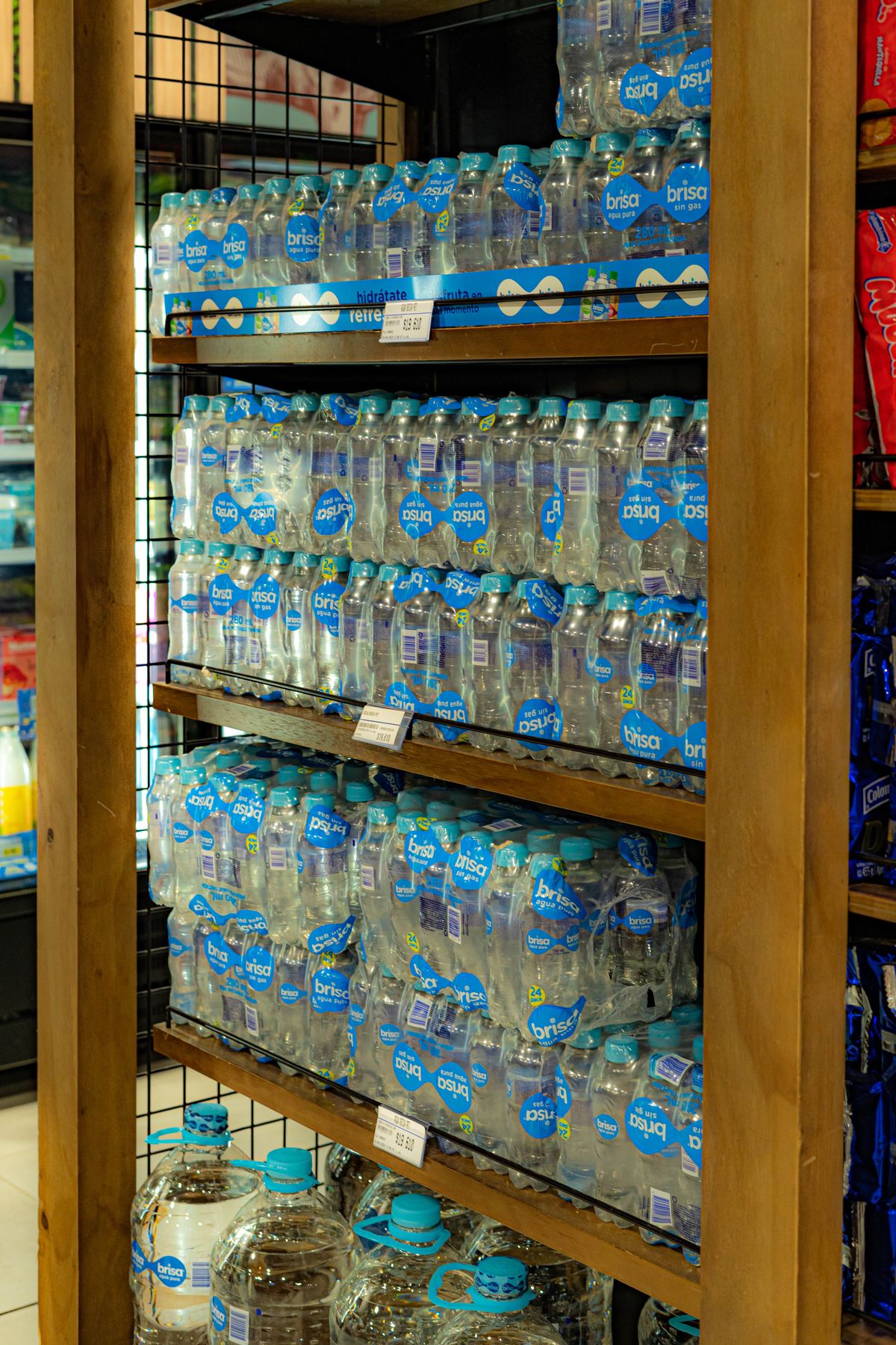 Shelves of bottled drinking water stacked in a store, an alternative to boiled tap water during a boil water notice