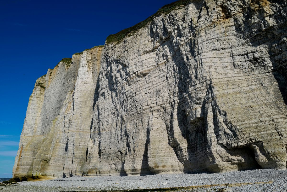 Rugged limestone cliff face showing the carbonate rock that makes well water hard in karst aquifers