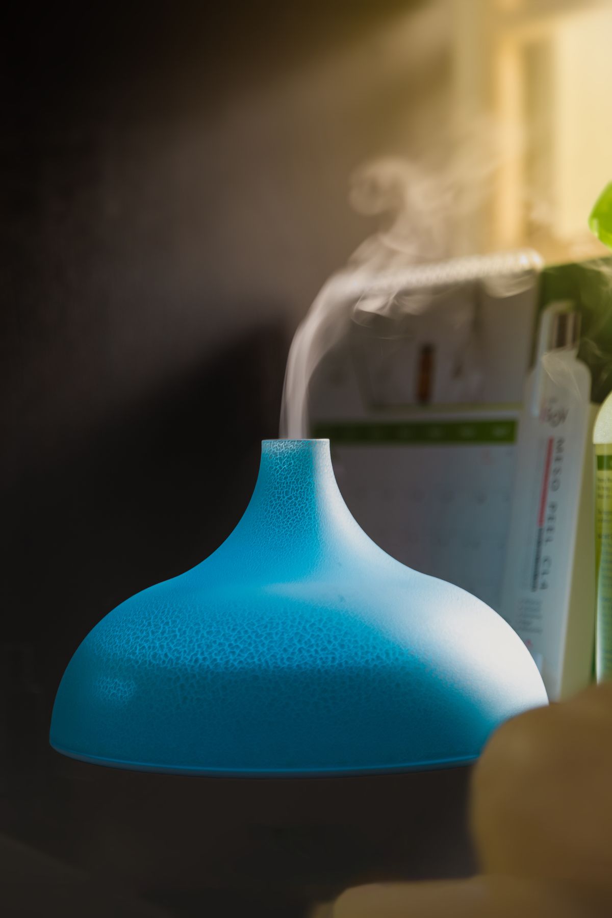 Close-up of a humidifier releasing vapour, creating a fine visible mist indoors