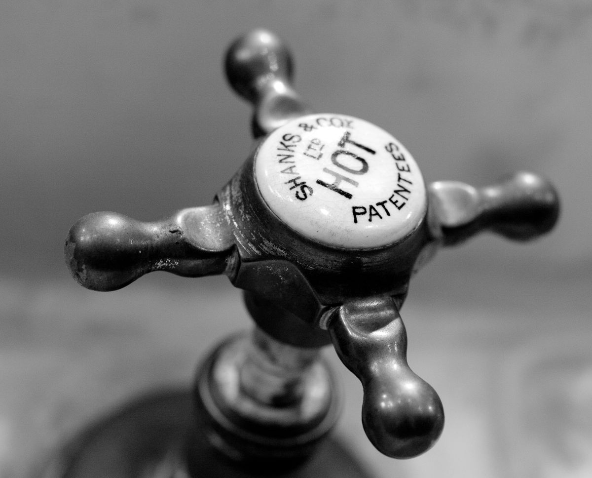 Vintage tap handle marked HOT, a reminder that hardness samples taken from the hot side read lower than the supply