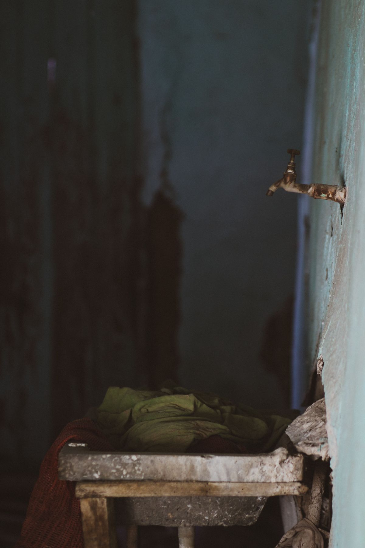 Neglected sink with a rusty faucet, the stained fixtures that iron and dirt in untreated well water leave behind