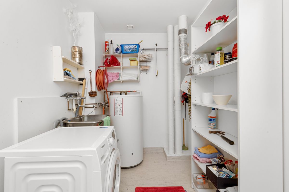 Tidy home utility room with washing machine and water heater, the kind of space where a newly installed water softener is diagnosed