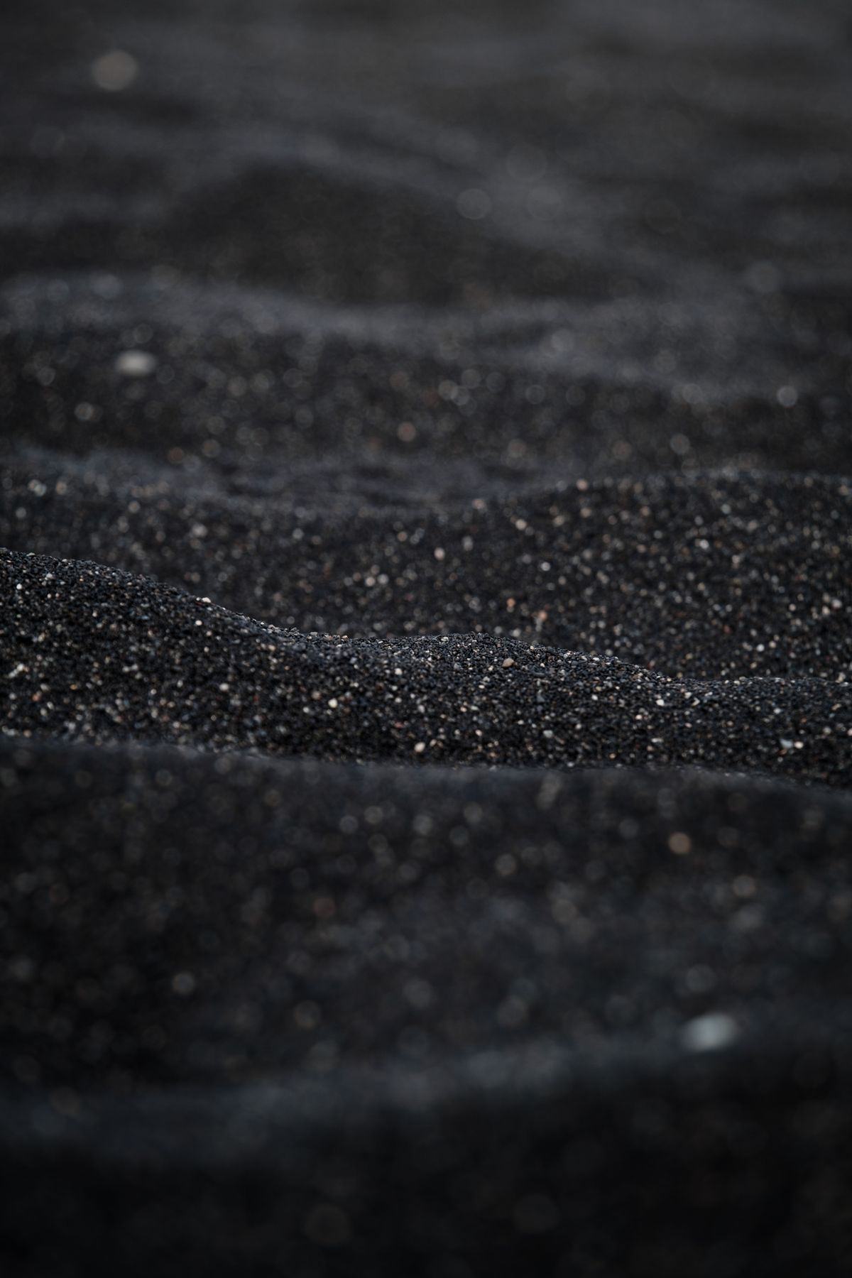 Fine dark granular texture resembling degraded water softener resin that has broken down inside the tank