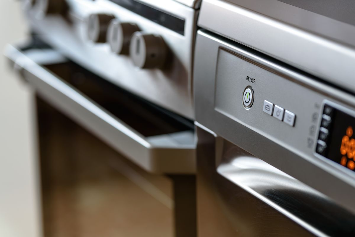 Stainless steel oven and dishwasher controls in a modern kitchen, the water-using appliances a polyphosphate cartridge or salt-free conditioner is bought to protect from scale