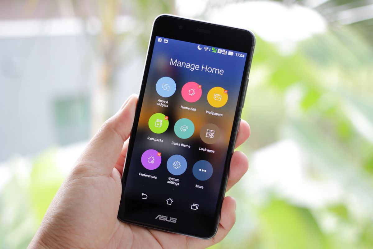 Hand holding a smartphone open to a home management app, the kind of phone alert an EcoWater softener with HydroLink Plus Wi-Fi sends for low salt and excess water use