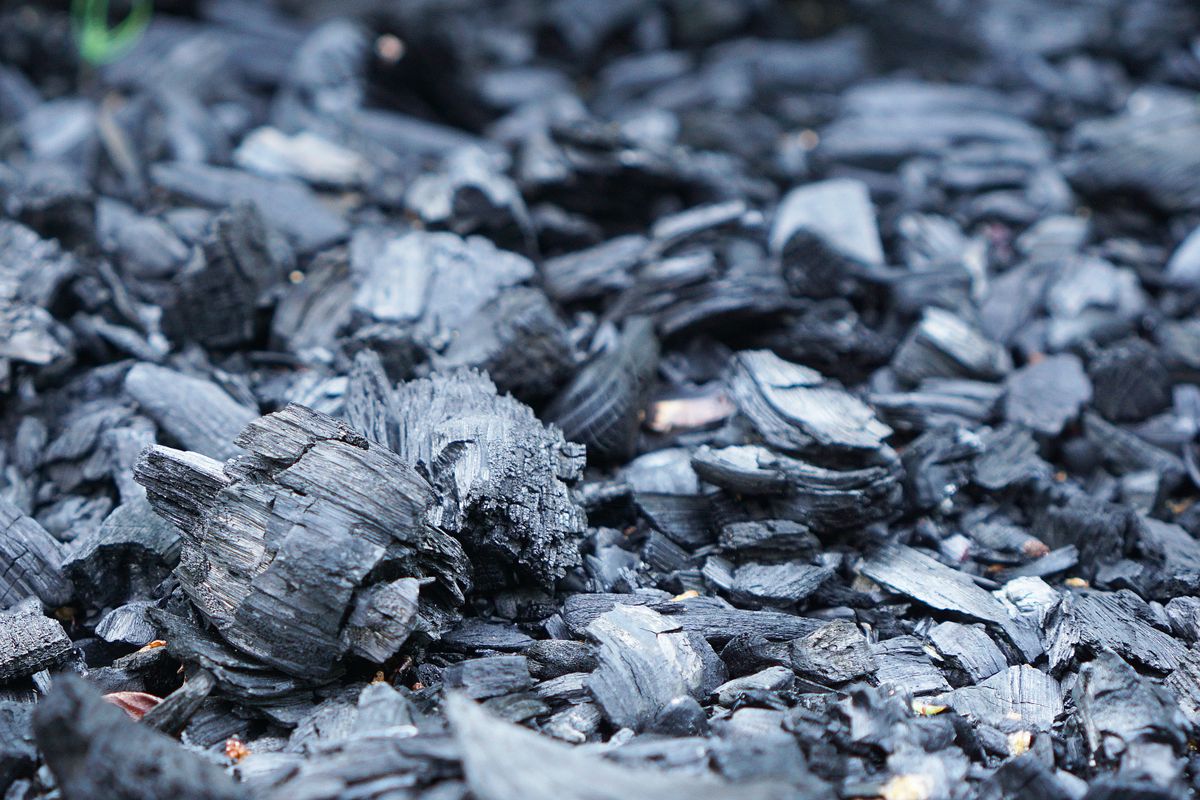 Close-up of dark granular material showing powdery texture, similar to the oxidised manganese that stains fixtures black