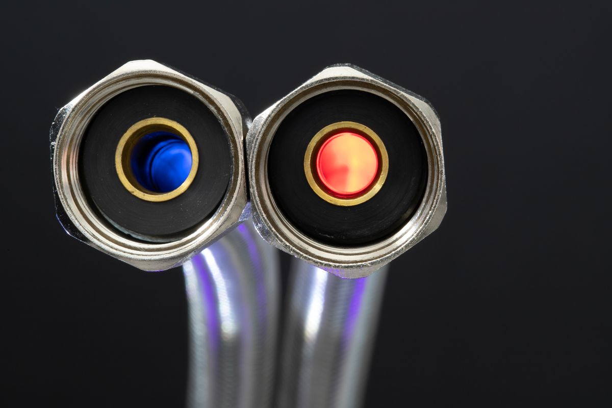 Pair of braided flexible water connectors with blue and red inner seals, the kind of connection hardware a buyer adds when installing an Aquasure or SpringWell softener