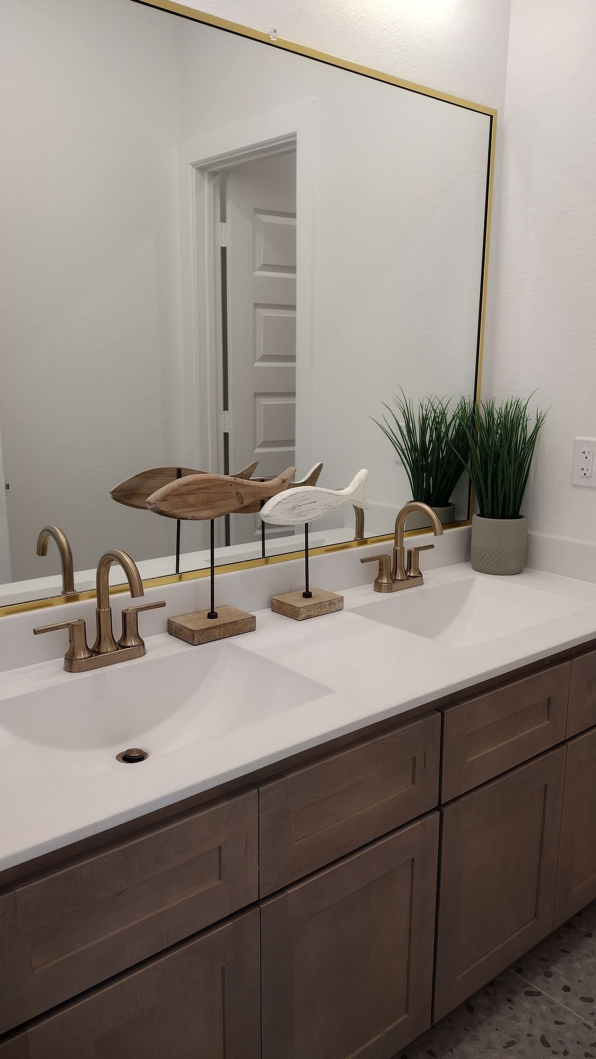 Double bathroom vanity with two brass faucets side by side, two taps in one house that can give different hardness test results