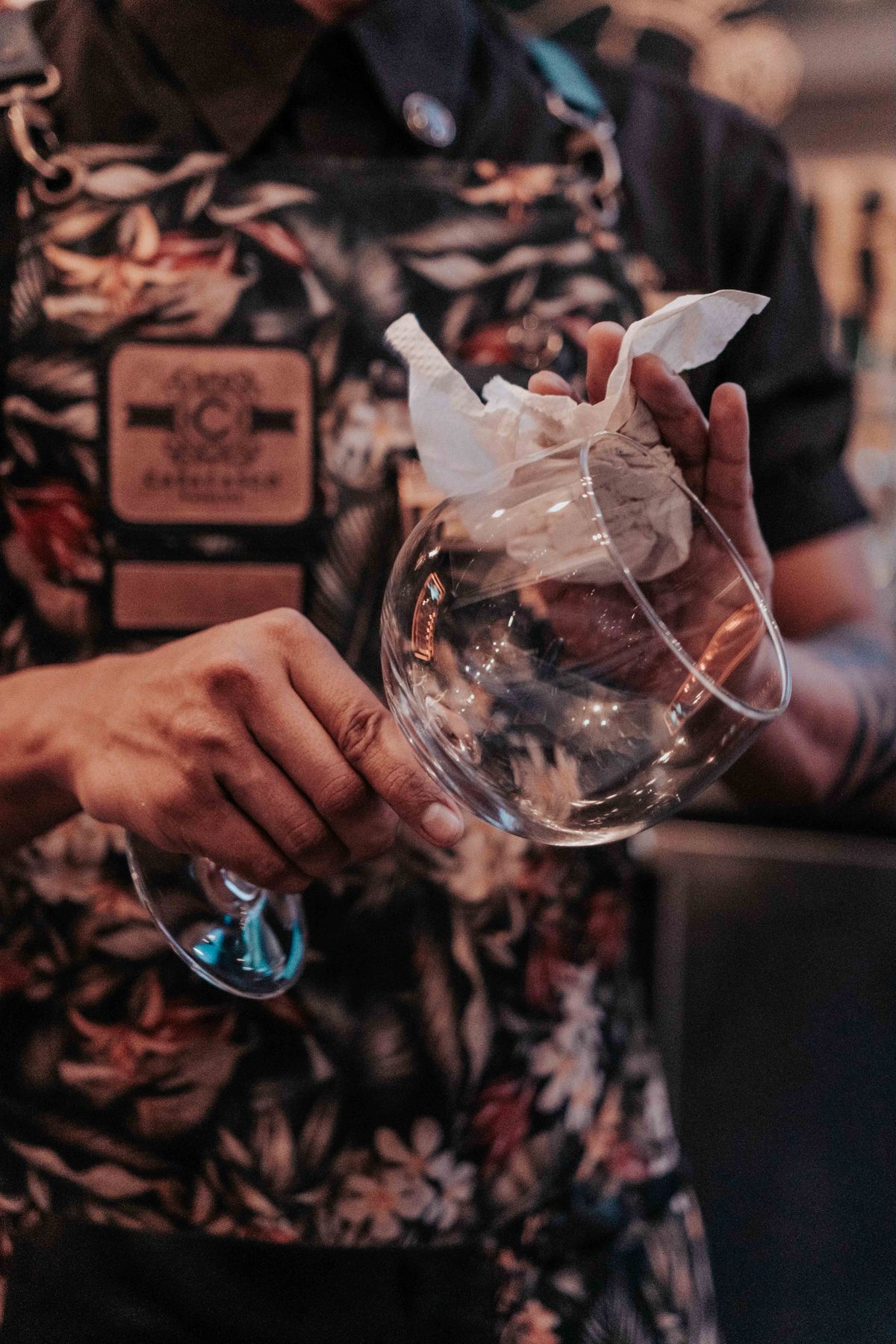Bartender polishing a wine glass with a cloth to a clear finish