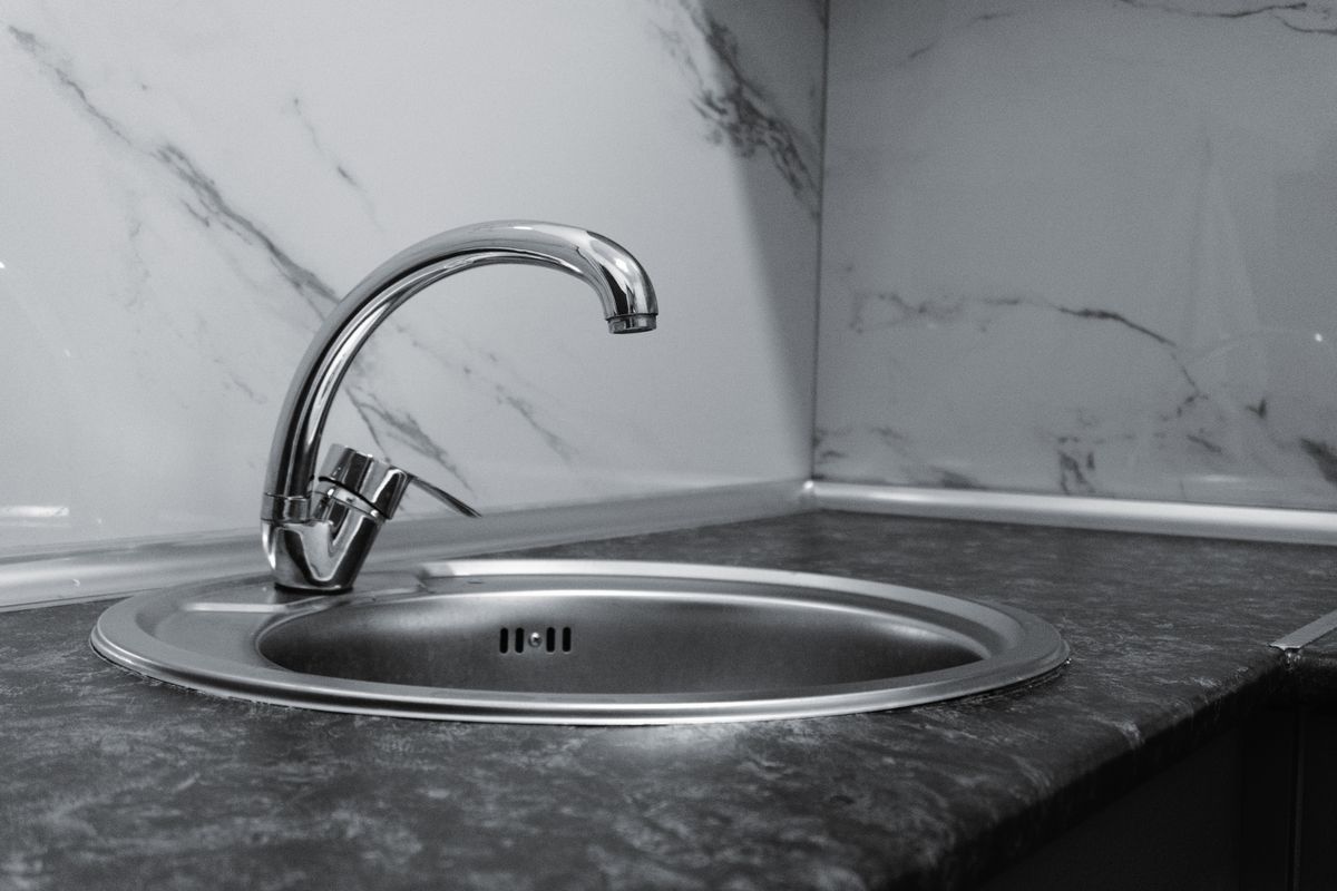 Modern stainless steel kitchen faucet, where sediment reaching the household shows up first in the aerator screen