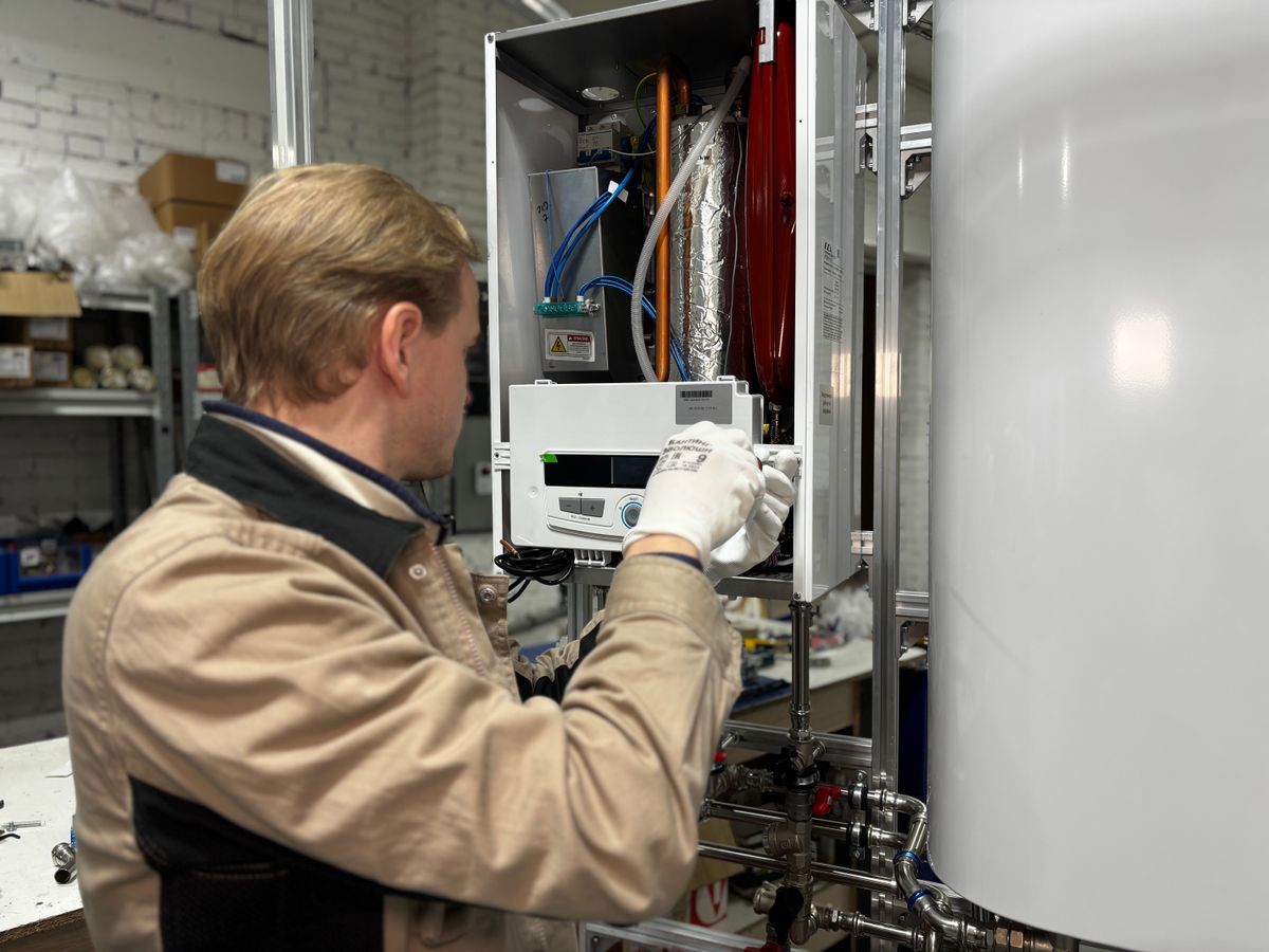 Technician servicing a household heating system