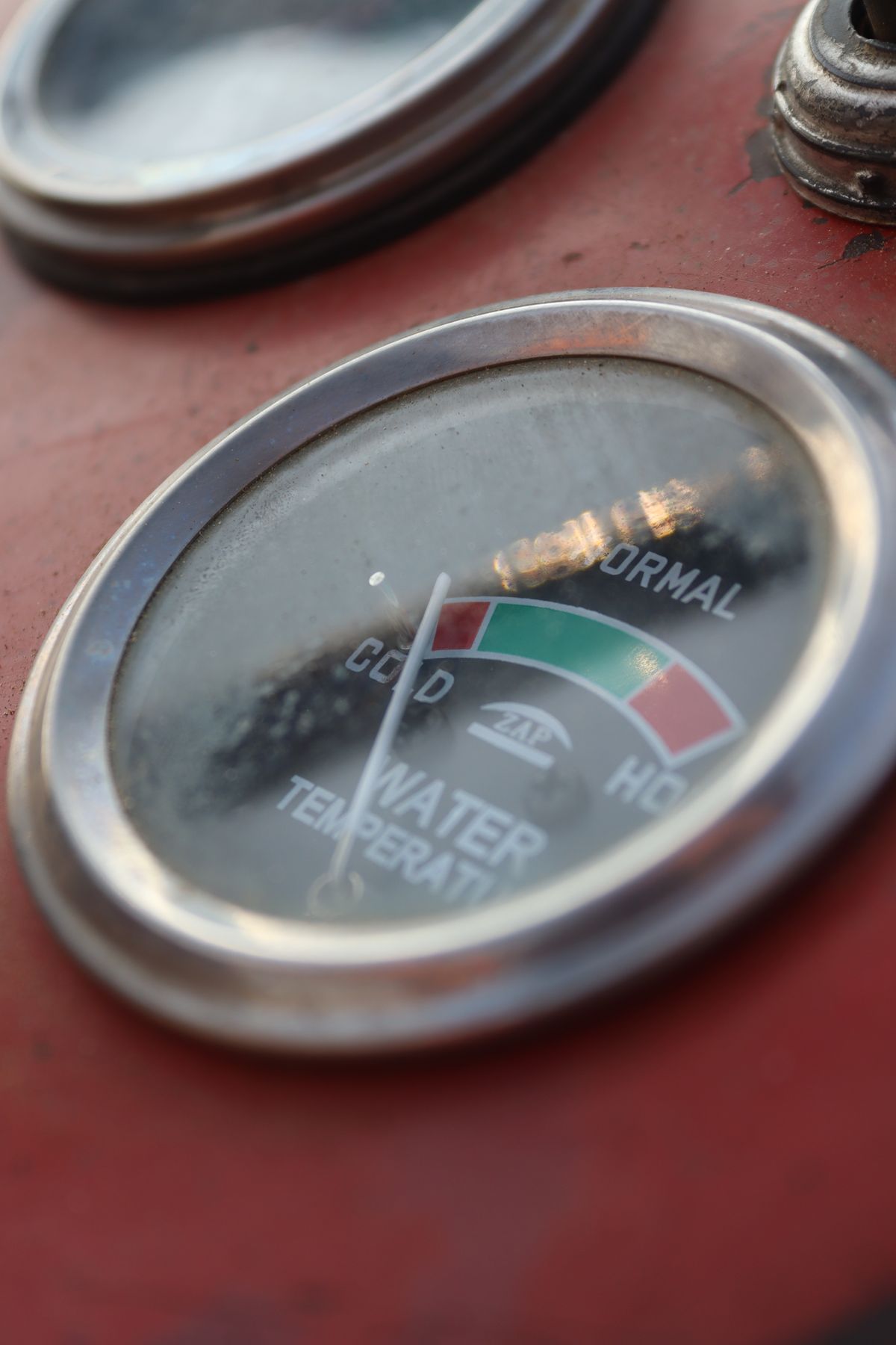 Close-up of a temperature gauge showing cold, normal and hot ranges