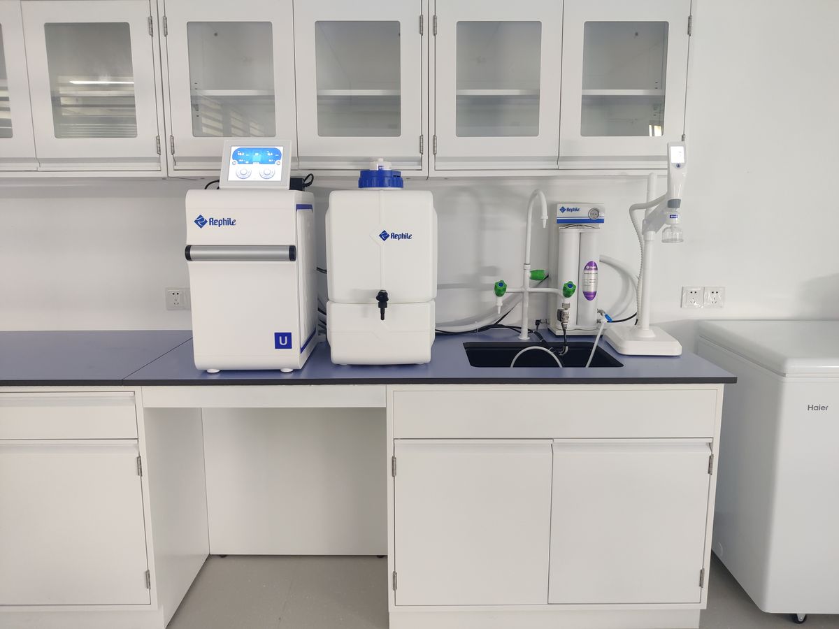 Modern laboratory water purification system with cartridge housings, illustrating carbon media placed ahead of a softener