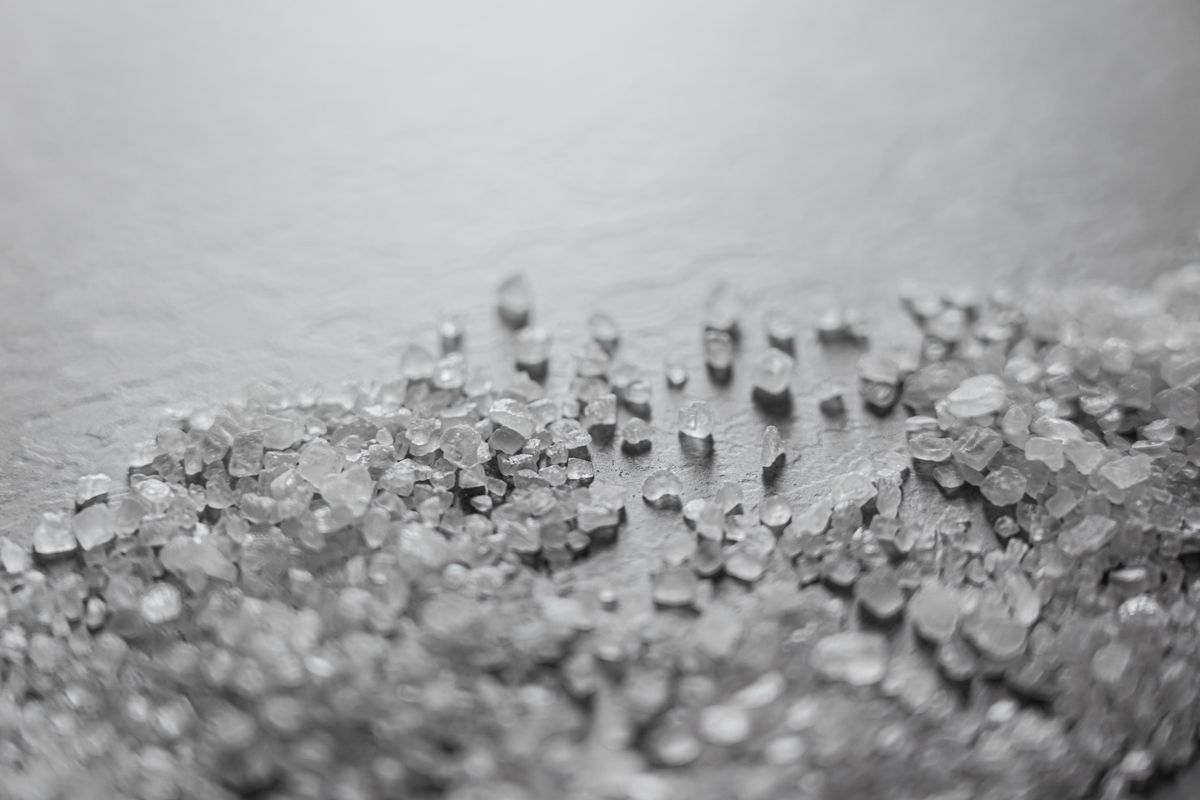 Coarse rock salt crystals, the consumable that must stay loose and available in the brine tank for a regeneration to restore capacity