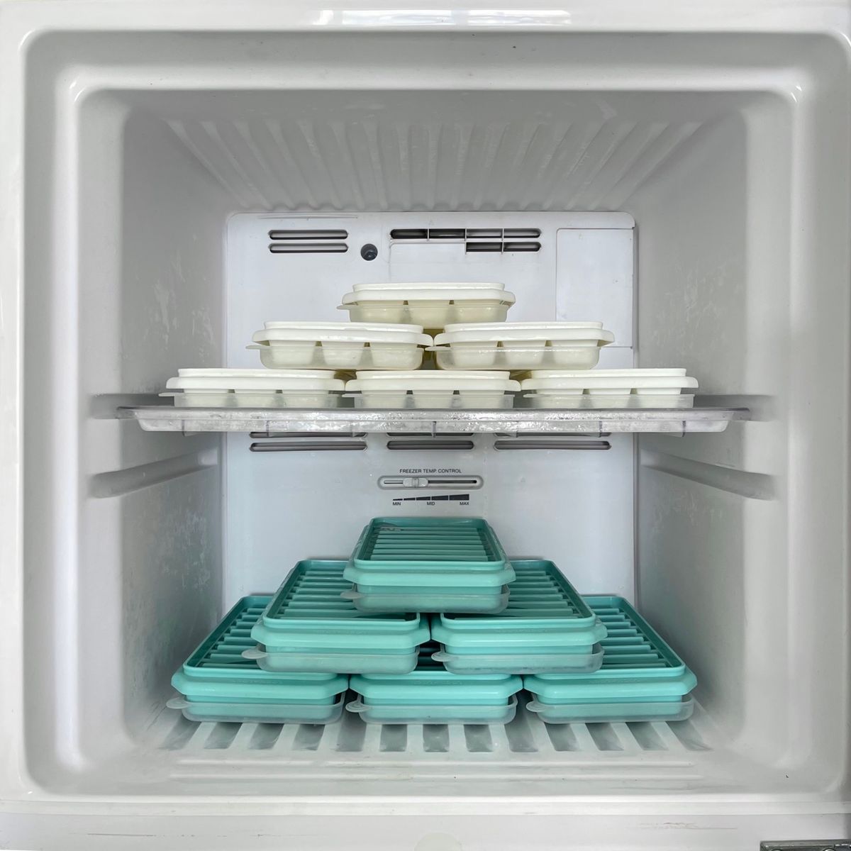 Freezer drawer stocked with ice trays in a home kitchen