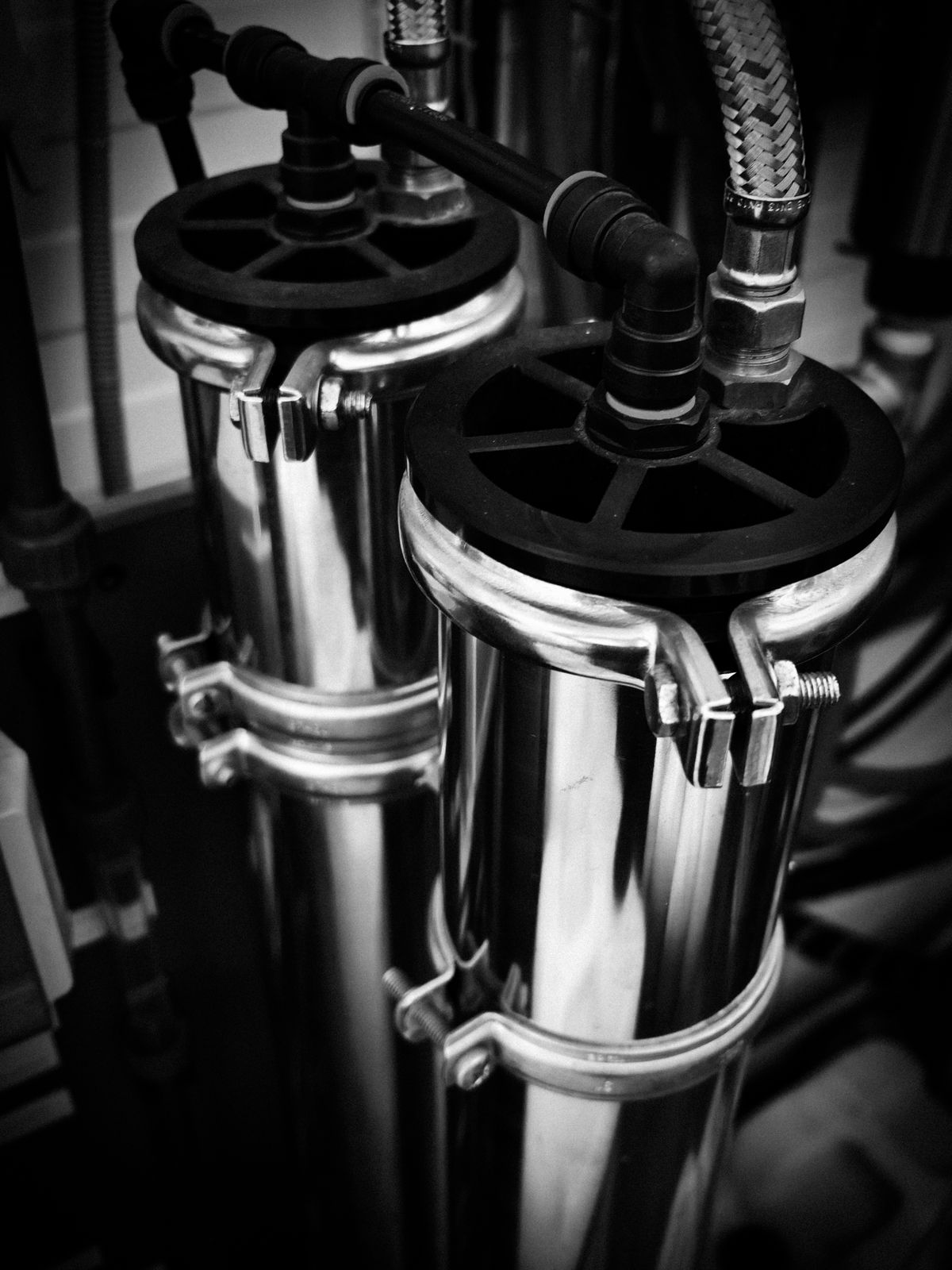 Assorted metal pipes and fittings, the plumbing that carries resin fines through the house after a softener media change