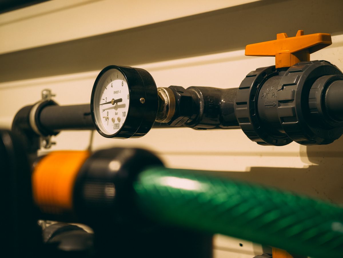 Pressure gauge on a plumbing manifold, the type of fitting used to sample immediately downstream of a softener