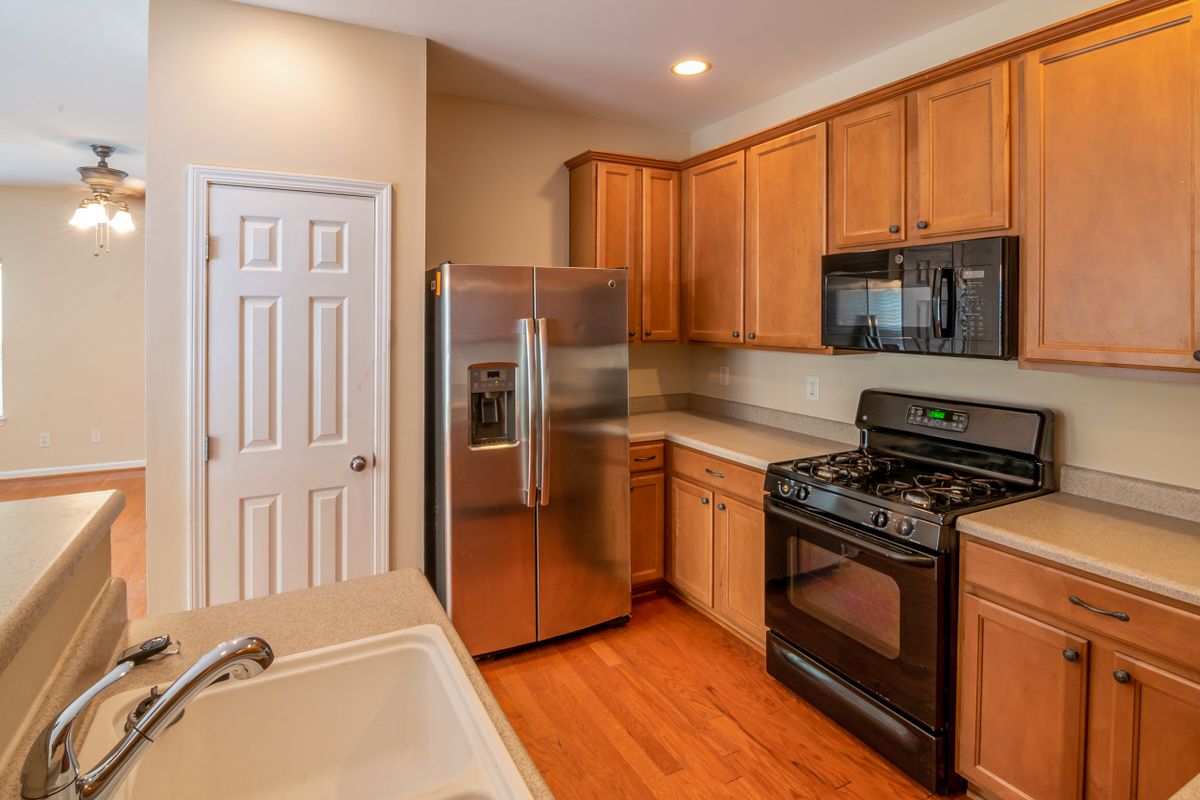 Contemporary kitchen with a stainless steel refrigerator and wooden cabinetry