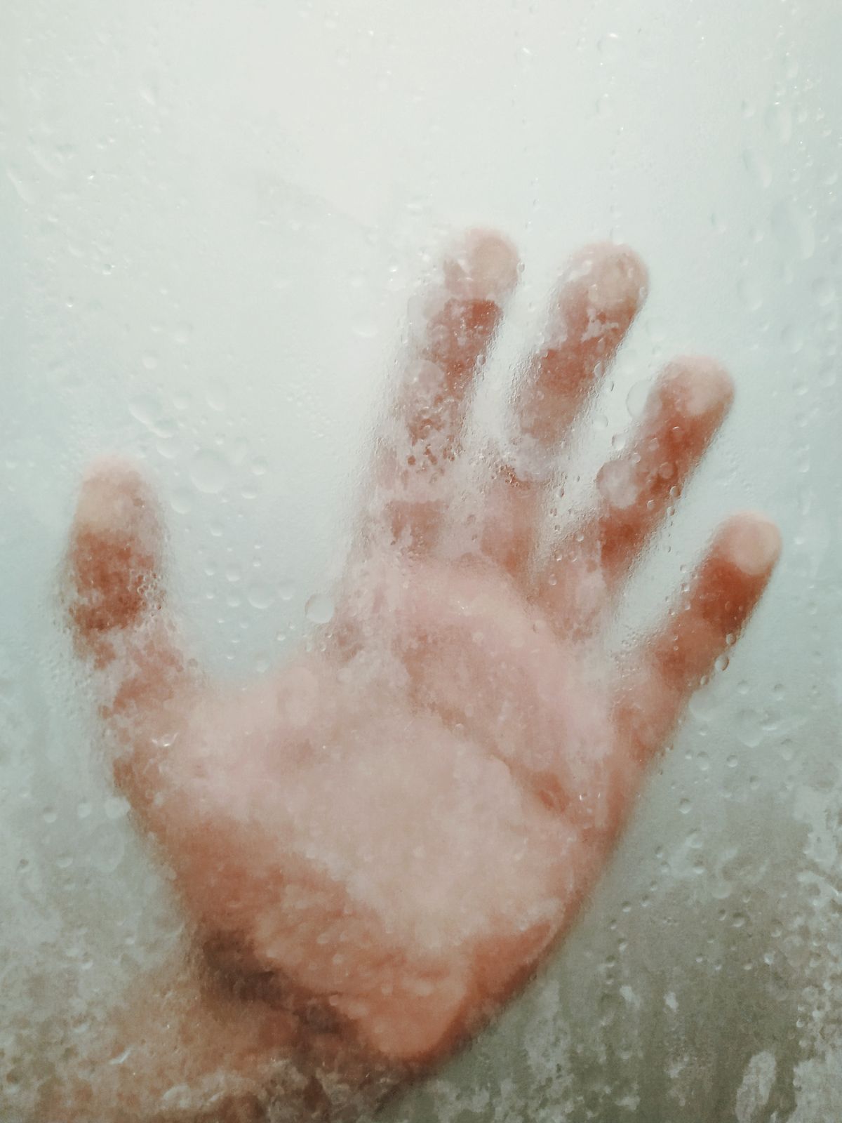 Water droplets clinging to glass, leaving the hazy film characteristic of silica rather than calcium scale