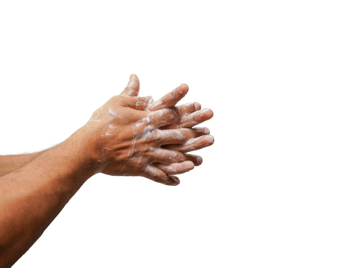 Close-up of hands being lathered with soap against a white background
