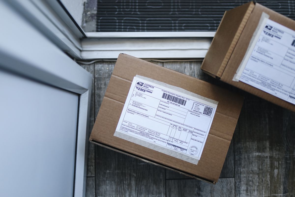 Two labelled shipping boxes left on a doorstep, how an online water softener arrives: in boxes, with installation left to the buyer