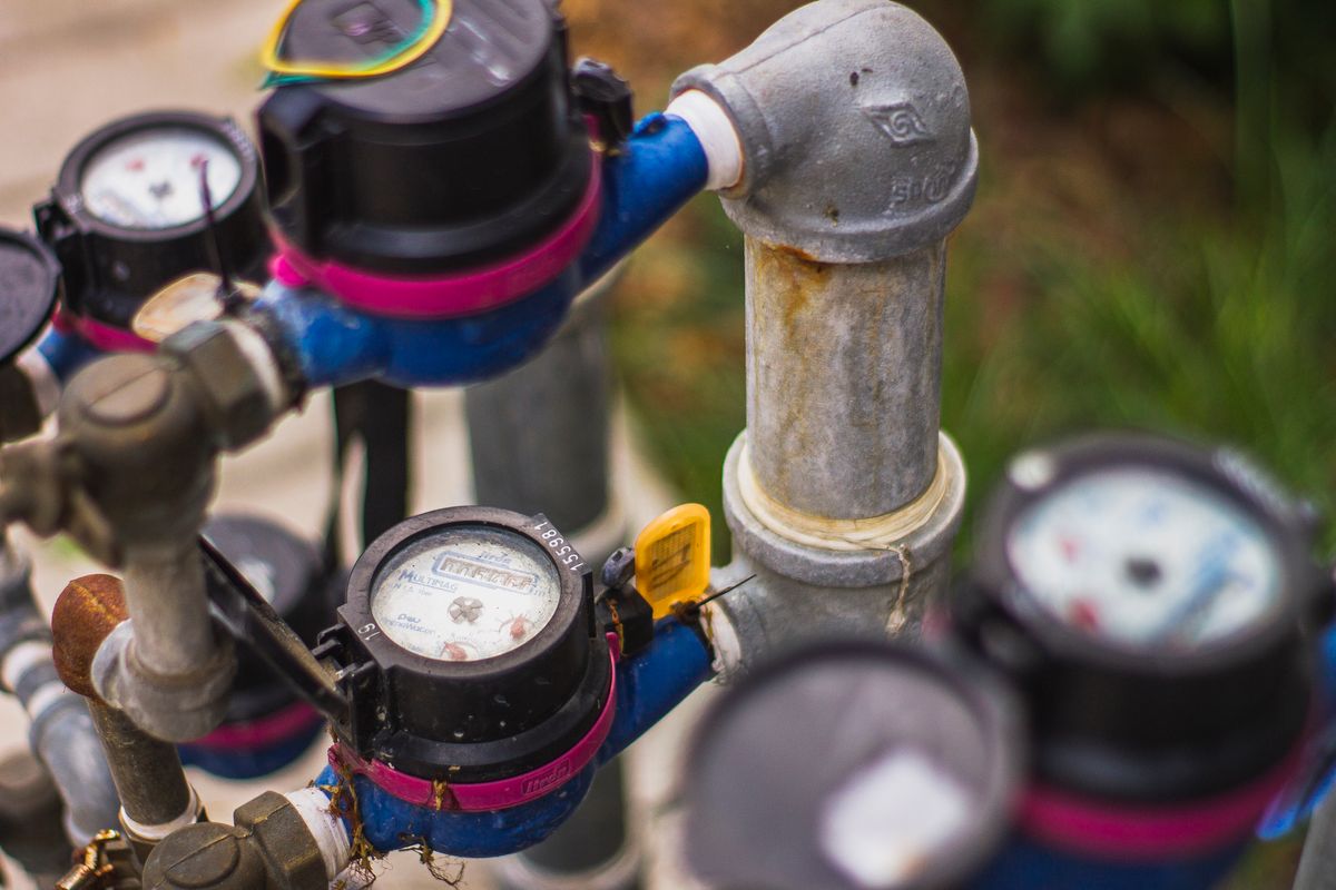 Water pressure gauges mounted on supply pipes used for testing scale reducing water pressure in a home