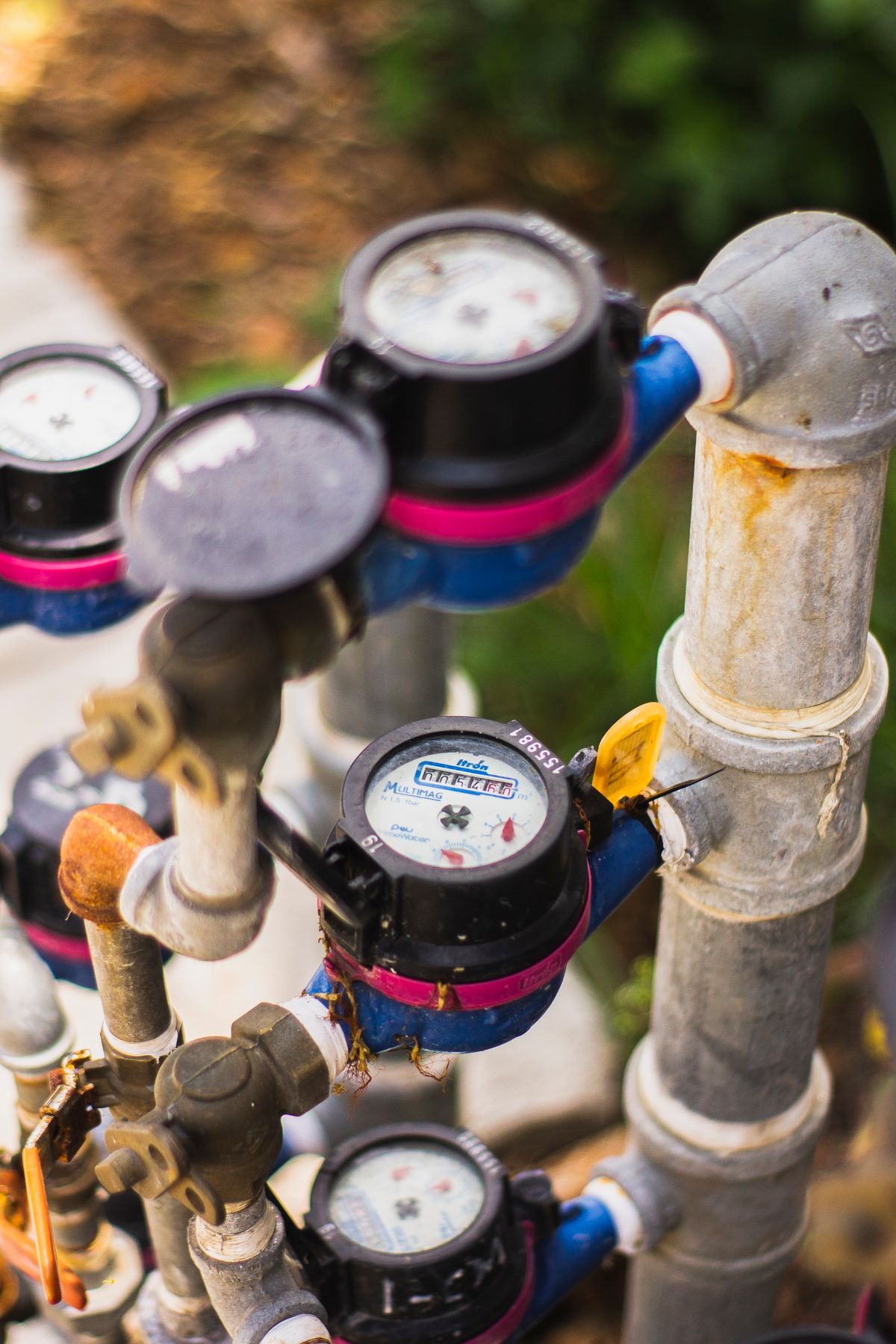 Bank of water meters connected by pipework, the metering that determines when a demand-initiated softener decides to regenerate
