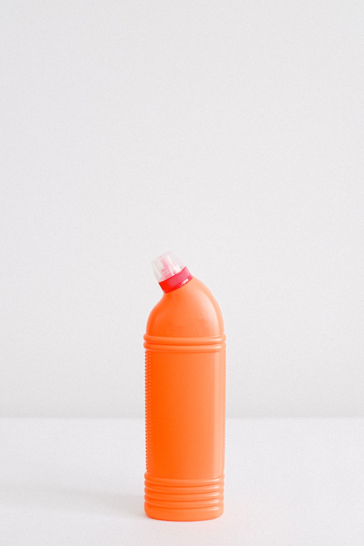 Sealed plastic container of household treatment liquid on a plain background, the resin cleaner that helps with iron but does nothing for organic or chlorine damage