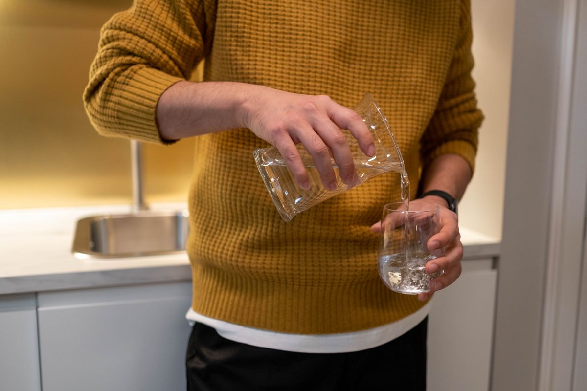 Water being poured from a jug into a clear glass, the sample used for a conductivity reading that confirms or rules out brine carryover