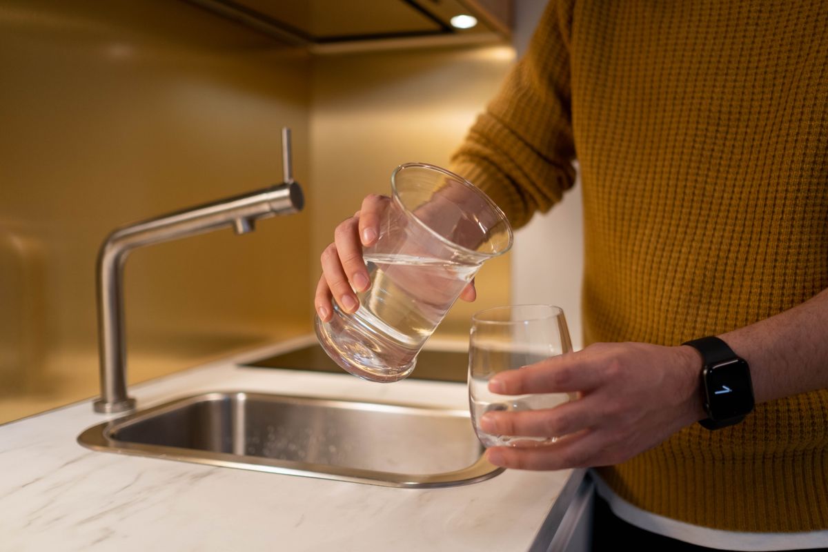 Water being poured into a glass in a kitchen, the final check that the symptom matches the diagnosis