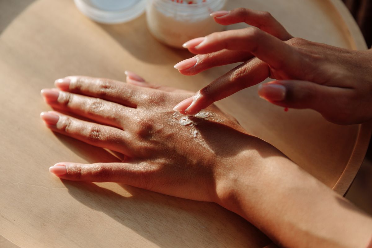 Person applying moisturising cream to their hands after washing