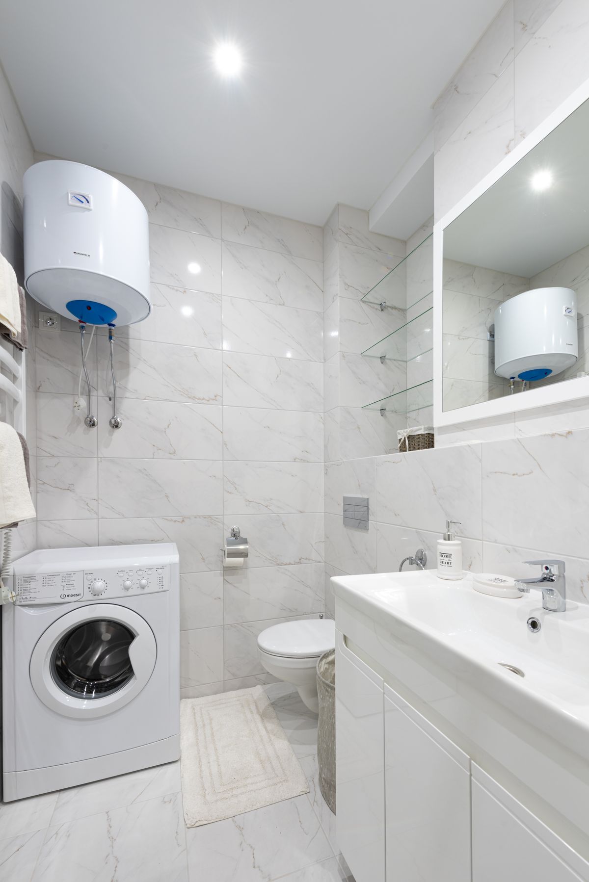 Wall-mounted tankless water heater unit in a bright utility room where scale in tankless water heater systems develops