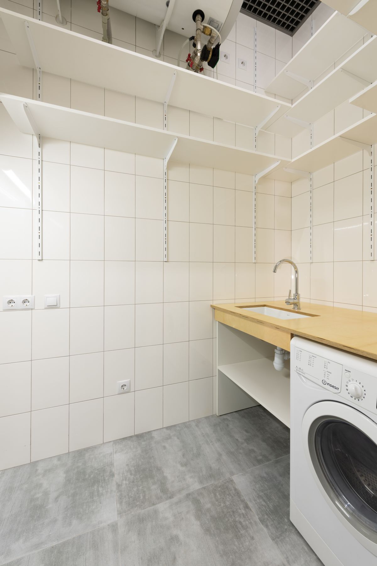 Laundry room with a utility sink beside a front-loading washing machine, a laundry tub being one of the receptors a softener drain line can discharge into