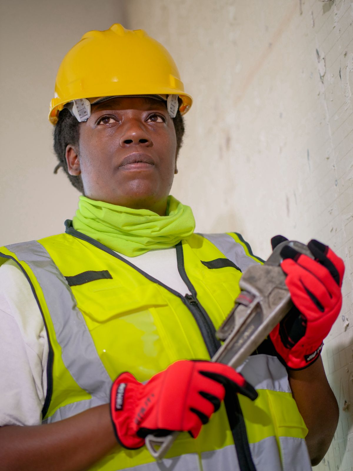 Professional plumber in protective gear holding tools and ready for work, the kind of trained technician a water softener fault sometimes calls for