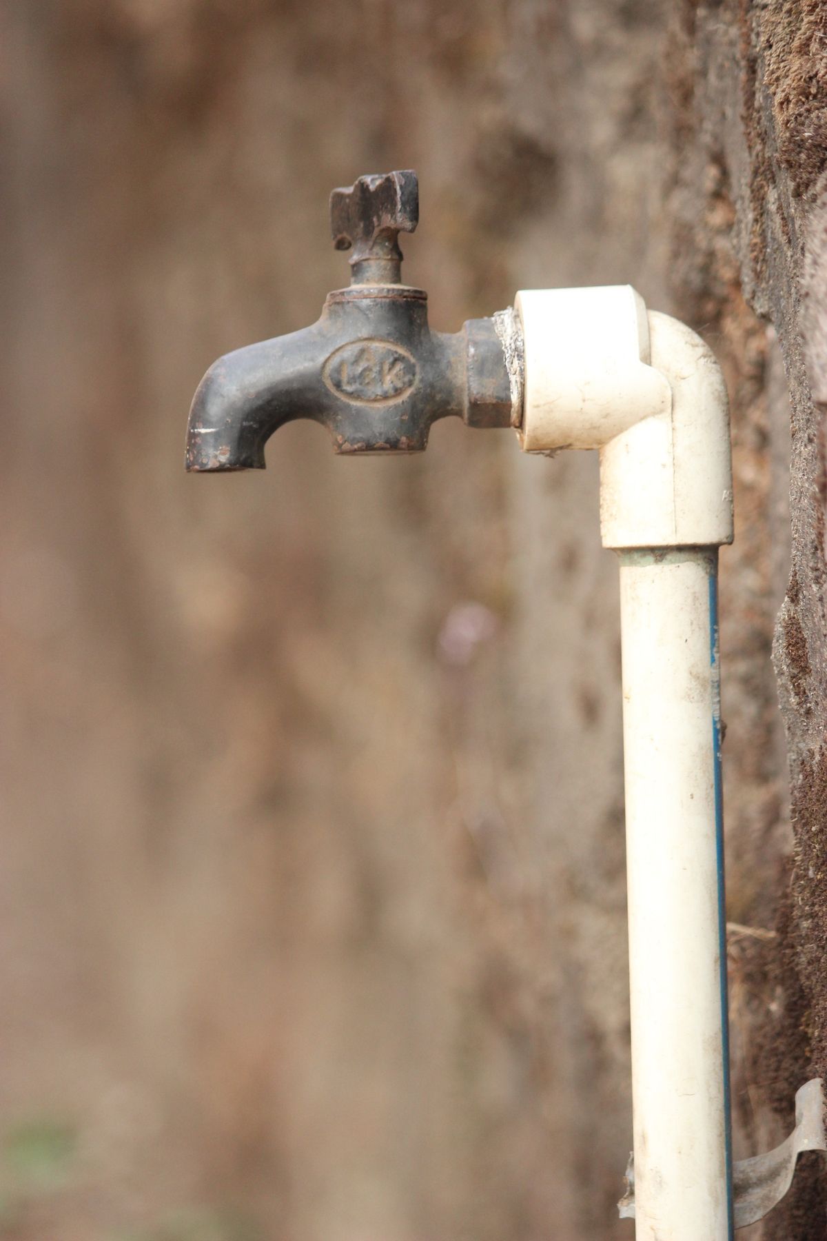 Corroded outdoor tap showing heavy rust deposits, the visual equivalent of iron fouling on softener resin