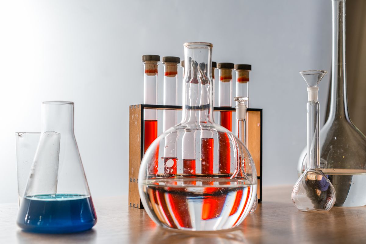 Test tubes holding coloured indicator solutions, the standard bench method for reading pH alongside hardness